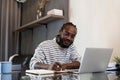 Young African American business man working with laptop and document on desk at home. work from home concept Royalty Free Stock Photo