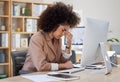 Young african american business woman looking stressed while using a computer at her desk in the office. Black woman Royalty Free Stock Photo