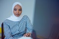 Young African American business woman sitting at her desk and smiling Royalty Free Stock Photo