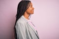 Young african american business woman standing over pink  background looking to side, relax profile pose with natural face Royalty Free Stock Photo