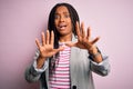 Young african american business woman standing over pink isolated background afraid and terrified with fear expression stop Royalty Free Stock Photo