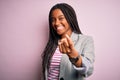 Young african american business woman standing over pink isolated background Beckoning come here gesture with hand inviting Royalty Free Stock Photo