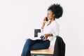 Young african american business woman talking on the phone while sitting on the chair Royalty Free Stock Photo