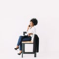 Young african american business woman talking on the phone while sitting on the chair Royalty Free Stock Photo