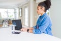 Young african american business woman working using computer laptop looking to side, relax profile pose with natural face with Royalty Free Stock Photo