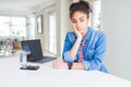 Young african american business woman working using computer laptop thinking looking tired and bored with depression problems with Royalty Free Stock Photo