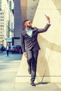 Young African American Businessman with beard, stretching arm, taking selfie on cell phone outside office in New York City Royalty Free Stock Photo