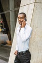 Young African American businessman with beard talking on cell phone outside in New York Royalty Free Stock Photo