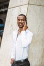 Young African American businessman with beard talking on cell phone outside in New York Royalty Free Stock Photo