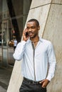 Young African American businessman with beard talking on cell phone outside in New York Royalty Free Stock Photo