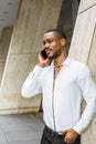 Young African American businessman with beard talking on cell phone outside in New York Royalty Free Stock Photo