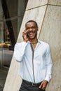 Young African American businessman with beard talking on cell phone outside in New York Royalty Free Stock Photo