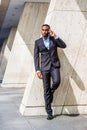 Young African American Businessman with beard talking on cell phone outside office in New York Royalty Free Stock Photo