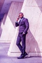 Young African American Businessman with beard talking on cell phone outside office in New York Royalty Free Stock Photo