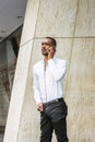 Young African American businessman with beard talking on cell phone, traveling in New York City Royalty Free Stock Photo