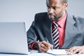 Young African American Businessman Being Sneaky On Laptop Royalty Free Stock Photo