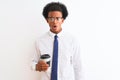 Young african american businessman drinking cup of coffee over isolated white background scared in shock with a surprise face, Royalty Free Stock Photo