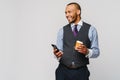 Young African-american Businessman holding Phone And Coffee to go over light grey background Royalty Free Stock Photo