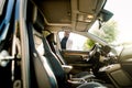 Young african american businessman opening his new car door. Side view, sunny day Royalty Free Stock Photo