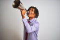 Young african american businessman screaming using vintage megaphone Royalty Free Stock Photo