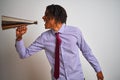 Young african american businessman screaming using vintage megaphone Royalty Free Stock Photo