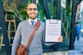 Young african american businessman smiling happy holding clipboard with agreement document at the city Royalty Free Stock Photo