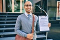 Young african american businessman smiling happy holding clipboard with agreement document at the city Royalty Free Stock Photo