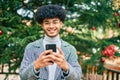 Young african american businessman smiling happy  using smartphone at the park Royalty Free Stock Photo