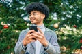 Young african american businessman smiling happy  using smartphone at the park Royalty Free Stock Photo