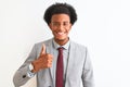 Young african american businessman wearing suit standing over isolated white background doing happy thumbs up gesture with hand Royalty Free Stock Photo