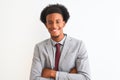 Young african american businessman wearing suit standing over isolated white background happy face smiling with crossed arms Royalty Free Stock Photo