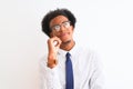 Young african american businessman wearing tie and glasses over isolated white background with hand on chin thinking about Royalty Free Stock Photo