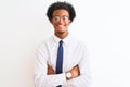Young african american businessman wearing tie and glasses over isolated white background happy face smiling with crossed arms Royalty Free Stock Photo