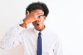 Young african american businessman wearing tie and glasses over isolated white background peeking in shock covering face and eyes Royalty Free Stock Photo