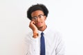 Young african american businessman wearing tie and glasses over isolated white background thinking looking tired and bored with Royalty Free Stock Photo