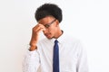 Young african american businessman wearing tie and glasses over isolated white background tired rubbing nose and eyes feeling Royalty Free Stock Photo