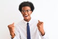 Young african american businessman wearing tie and glasses over isolated white background very happy and excited doing winner Royalty Free Stock Photo