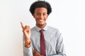 Young african american businessman wearing tie standing over isolated white background with a big smile on face, pointing with Royalty Free Stock Photo