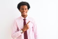 Young african american businessman wearing tie standing over isolated white background cheerful with a smile of face pointing with Royalty Free Stock Photo