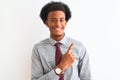 Young african american businessman wearing tie standing over isolated white background cheerful with a smile of face pointing with Royalty Free Stock Photo