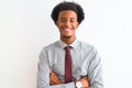 Young african american businessman wearing tie standing over isolated white background happy face smiling with crossed arms Royalty Free Stock Photo