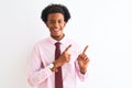 Young african american businessman wearing tie standing over isolated white background smiling and looking at the camera pointing Royalty Free Stock Photo