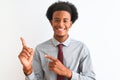 Young african american businessman wearing tie standing over isolated white background smiling and looking at the camera pointing Royalty Free Stock Photo