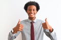 Young african american businessman wearing tie standing over isolated white background success sign doing positive gesture with Royalty Free Stock Photo