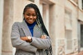 Young african american businesswoman with arms crossed smiling happy at the city Royalty Free Stock Photo