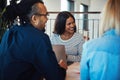 Young African American businesswoman laughing with office collea