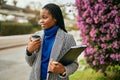 Young african american businesswoman smiling happy drinking coffee at the city Royalty Free Stock Photo