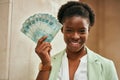 Young african american businesswoman smiling happy holding brazilian real banknotes at the city