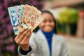 Young african american businesswoman smiling happy holding canadian dollars at the city Royalty Free Stock Photo