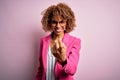 Young african american businesswoman wearing glasses standing over pink background Beckoning come here gesture with hand inviting